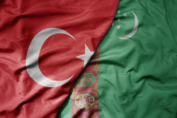 big waving national colorful flag of turkey and national flag of turkmenistan .