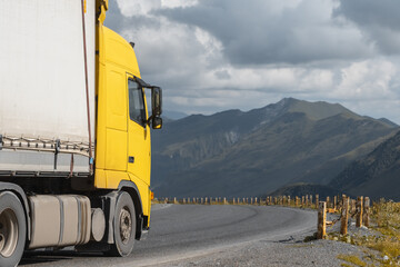 semi truck driving through mountain road pass