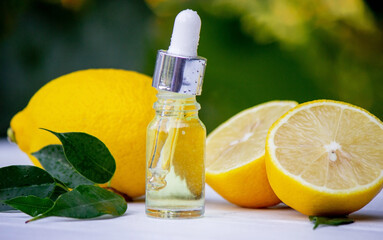 lemon oil in jars, fresh lemon. Selective focus.