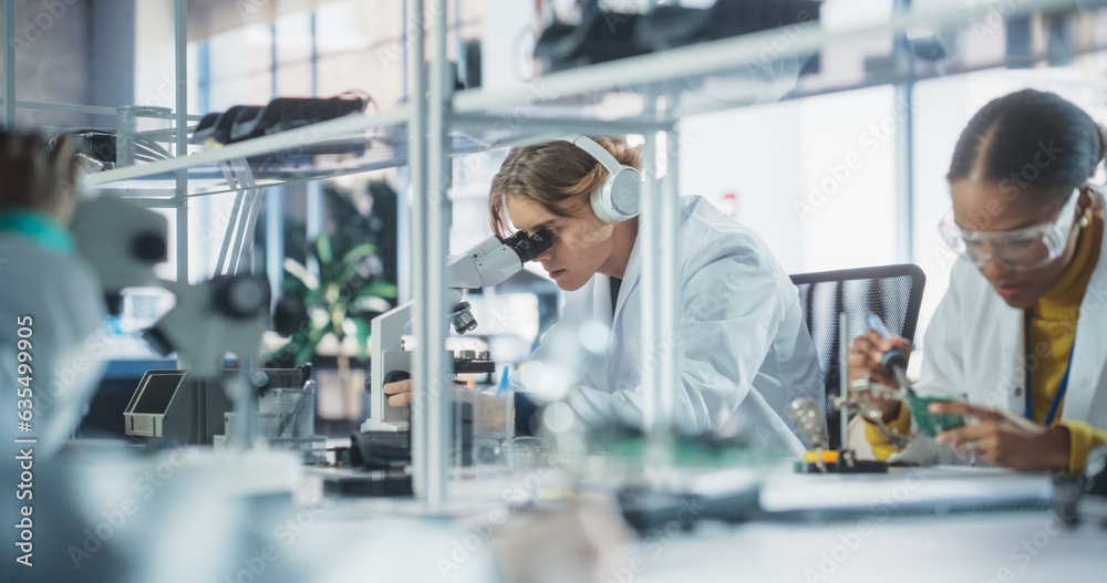 Poster Team of Multiethnic Science Students Conducting Electronics Experiments in a University Workshop. Diverse Young Classmates Using Microscopes, Working with Soldering Iron to Create a Circuit Board
