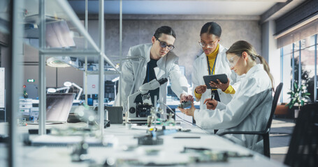 Young Team of Female and Male Students Working Together in Laboratory Classroom, Collaborating on a College Research Project. Young Scholars Talking, Study Electronics or Science Engineering