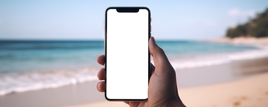 Hand holding mobile phone with cut out screen on summer beach resort background
