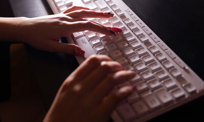 Female hand typing on the keyboard