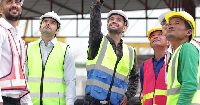 Success teamwork. Ethnic diversity worker people. Group of professional Construction engineering people wearing hardhat safety helmet meeting at Prefabricated concrete walls Industry Factory