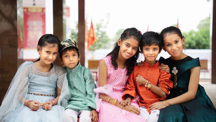 Little kids wearing tradional indian dress enjoying Indian festival. Children in ethnic wear looking at camera