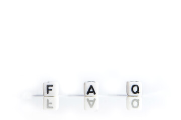 faq word or concept made by white letter cubes on white and gray background, frequently asked...