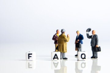 faq word or concept made by white letter cubes on white and gray background, frequently asked...