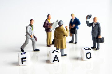 faq word or concept made by white letter cubes on white and gray background, frequently asked questions abbreviation with miniature businessmen figurines having a gathering