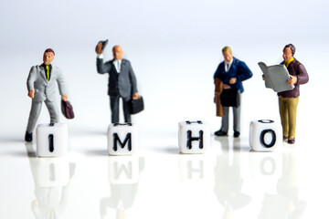 imho word or concept made by white letter cubes on white and gray background with miniature...
