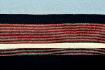 Fabric design background with multicolored horizontal stripes form a pattern, space for text close-up