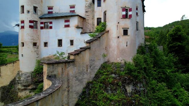 Scenic fairytale medieval castles of Italy - Castel Bragher in Trentino Alto Adige. surrounded by vineyards and forest. aerial drone video