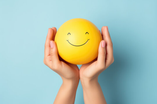 Hands holding happy smile face, mental health positive thinking and growth mindset, mental health care recovery to happiness emotion.