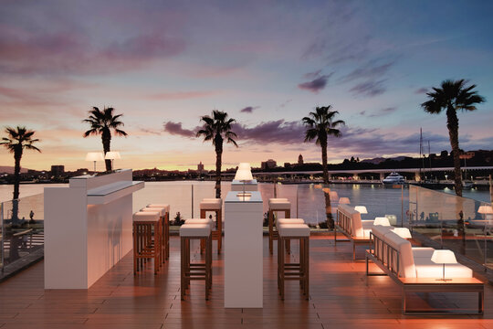 3D illustration of a modern rooftop bar overlooking a harbor at sunset