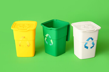 Containers for garbage on green background. Recycling concept