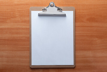 clip board with blank sheet on wooden background