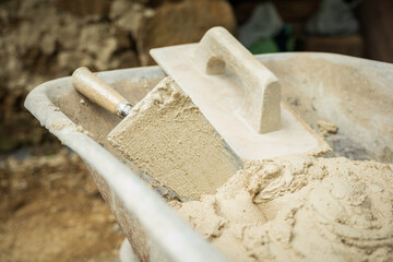 Construction materials and tools in a wheelbarrow ready to be used in the construction and repair of buildings.