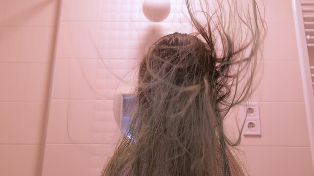 Wet girl hair develops in the bathroom