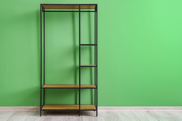 Empty shelving unit near green wall in room