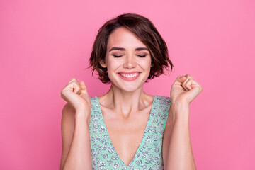 Photo of young funny sweet woman bob brown hair fists up desirable reaction cheerful hooray winsome isolated on pink color background