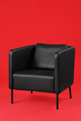 Black armchair on red background