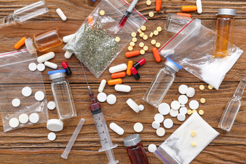 Composition with different drugs and syringes on wooden background