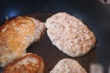 pancakes in a pan. Frying Pan On The Stove. Pancake Burned On The Pan. Mans Hand Turns The Pancake To The Other Side. He Lingers When He Sees That The Pancake Has Burned.