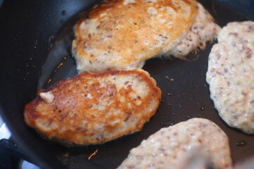 pancakes in a pan. Frying Pan On The Stove. Pancake Burned On The Pan. Mans Hand Turns The Pancake To The Other Side. He Lingers When He Sees That The Pancake Has Burned.