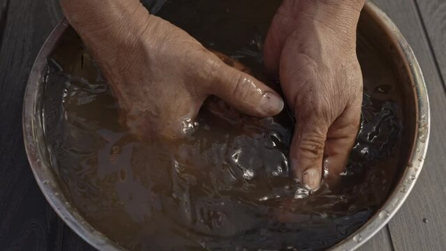 
man hands cleaning potato with water in 4k on table