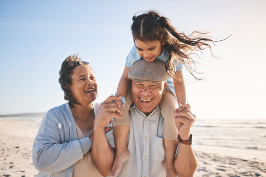 Happy, beach and girl bonding with her grandparents on a tropical family vacation or adventure. Smile, sunset and child playing with her grandmother and grandfather by the ocean on holiday together.
