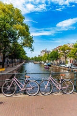 Fototapeta premium Pink bikes along canal in Amsterdam