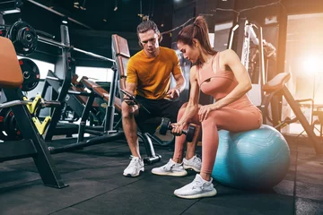 Foto op Canvas sport woman training muscle in private class gym with personal trainer help support © Quality Stock Arts