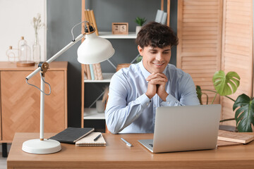 Young man having job interview online at home
