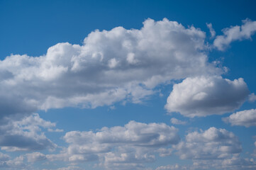 Cumulus clouds against the blue sky on a summer day.
