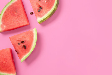 Composition with pieces of ripe watermelon on pink background, closeup