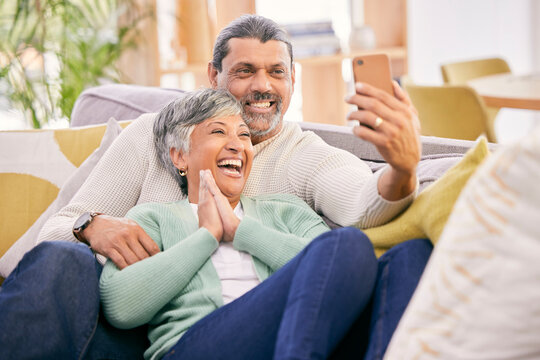 Laughing, selfie and a senior couple with a phone on the sofa for communication, social media or a video call. Smile, house and an elderly man and woman taking a photo with a mobile on the couch