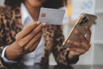 Women holding credit card and using smartphones at home.Online shopping, internet banking, store online, payment, spending money, e-commerce payment at the store, credit card, concept