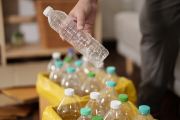Recycling Plastic Environment conceptual, man with plastic bottle on paper bin.
