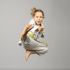 girl performs martial arts flying kick