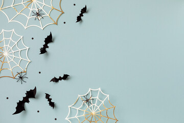 Halloween party decorations from bats, spider web and confetti top view. Happy halloween minimal...