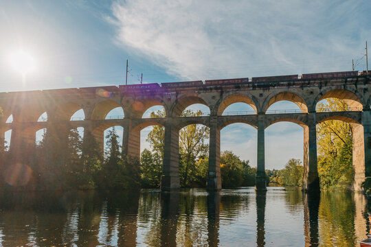 Railway Bridge with river in Bietigheim-Bissingen, Germany. Autumn. Railway viaduct over the Enz River, built in 1853 by Karl von Etzel on a sunny summer day. Bietigheim-Bissingen, Germany. Old