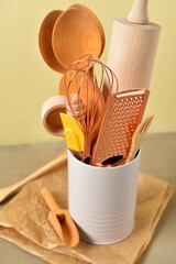 Set of baking utensils on brown table near wall