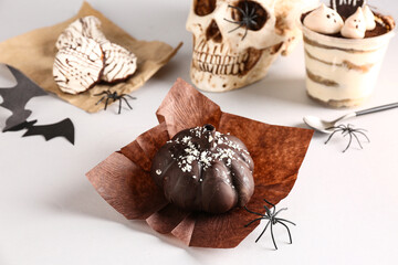 Delicious chocolate cake and spiders for Halloween celebration on white background, closeup