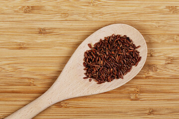 Flat Lay of delicious Red Rice isolated with  wooden spoon