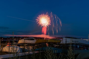 Fireworks above a dinghy boat rack at the beach