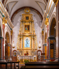 Altar and altarpiece inside a Catholic church.