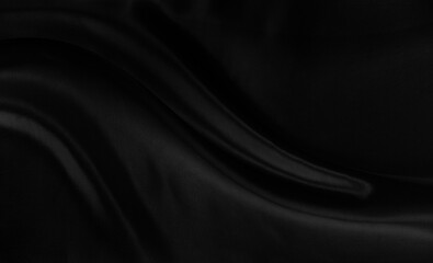 Black gray satin dark fabric texture luxurious shiny that is abstract silk cloth background with patterns soft waves blur beautiful.