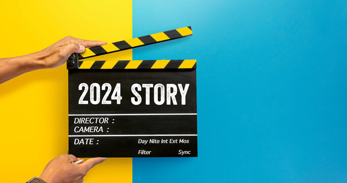 A new story begins in year 2024.Film industry worker holding film slate to tell a story