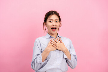 Young asian woman use both hands touching on the chest and open mouth while feeling shocked and scared
