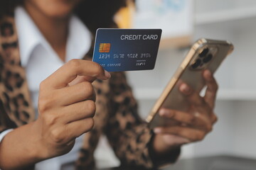 Women holding credit card and using smartphones at home.Online shopping, internet banking, store online, payment, spending money, e-commerce payment at the store, credit card, concept