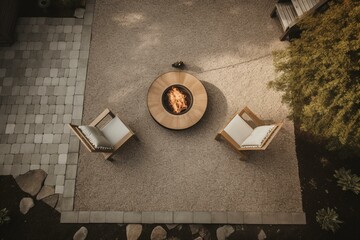 Bird's-eye view of gravel-floored patio featuring a wood-fired fire pit, torch for ambiance, and stylish brown outdoor chair. Generative AI